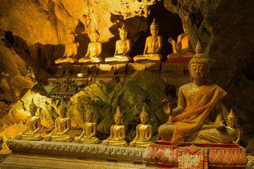Several ancient Buddha sculptures in the old Wat Tham Khao Luang Cave Temple