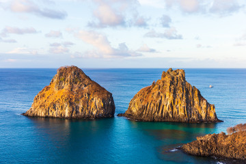 View of Morro dos Dois Irmãos and Baia dos Porcos in Fernando de Noronha, Brazil near sunset time.