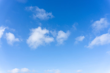Fototapeta na wymiar Beautiful form of white fluffy clouds on vivid blue sky in a suny day