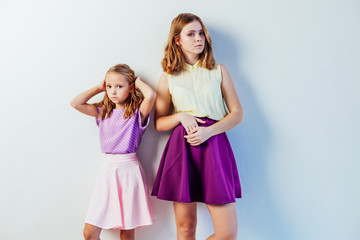two fashionable girls sisters in beautiful clothes portrait