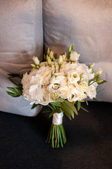 White bouquet of roses on the sofa