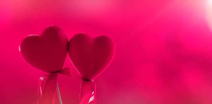 Pink decorative heart in red bokeh background