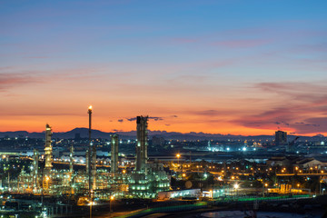 Fototapeta na wymiar Oil refinery and petrochemical plants, natural gas storage tanks, industrial city at sunrise