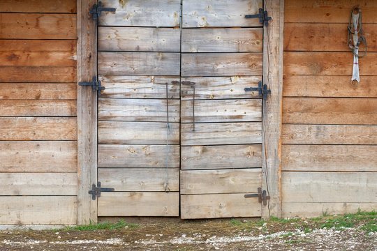 Wooden barn wall with wooden closed door