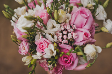 Delicate bouquet of pink and white flowers in the hands of the bride 214