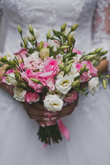 Delicate bouquet of pink and white flowers in the hands of the bride 214