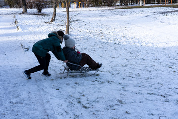 Little boy and girl sledding