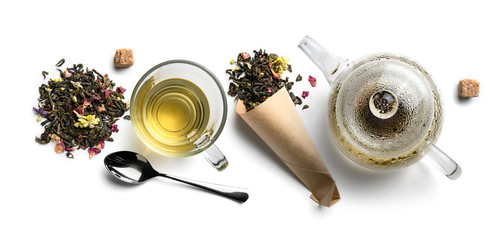Green tea with natural aromatic additives and accessories. Top view on white background
