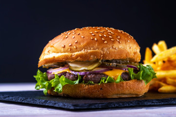 hamburger with bacon on black background