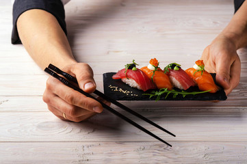 fresh sashimi with green on wooden table
