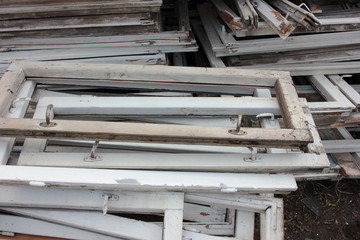 Heap of construction debris from old wooden window frames with glass outdoors. Reusable waste from...