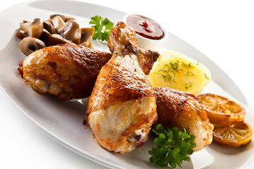 Barbecue chicken drumsticks with boiled potatoes and mushrooms