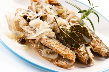 Fried herrings in vinegar on white background