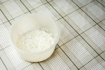 Long grain rice for cooking pilaf on kitchen table.