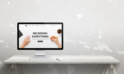 Web design studio with computer  display and modern agency web page. Copy space beside. Modern,...