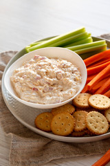 Homemade Pimento Cheese Dip with carrots, celery and crackers, side view. Close-up.