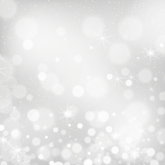 Silver bokeh background. Christmas glowing lights with sparkles. Holiday decorative effect.