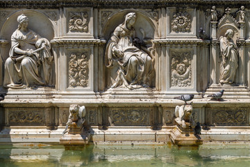 Fountain decoration details in the historic centre of Siena, Italy