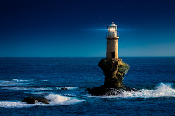 The beautiful Lighthouse Tourlitis of Chora at night. Andros island, Cyclades, Greece © proslgn