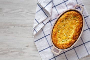 Homemade Cheddar Corn Pudding Casserole, top view. Flat lay, top view, from above. Copy space.