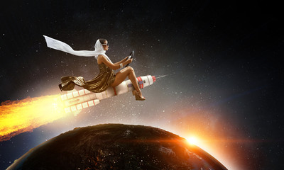 Obraz na płótnie Canvas Woman on space rocket . Mixed media