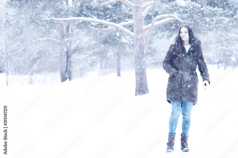 Wall mural beautiful girl in a beautiful winter snow