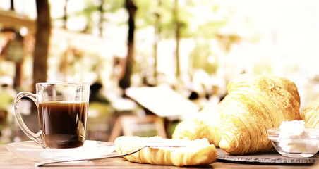 Fresh pastries on the table. French flavored croissant and coffee.