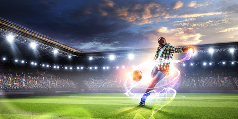 Soccer man in action with ball. Mixed media