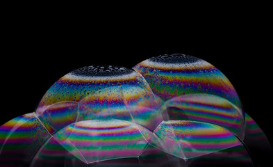 Soap bubbles with a pattern on a black background