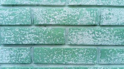 A brick wall. Ceramic brickwork. Brick fence. Neatly and evenly laid brick. Green wall of a...