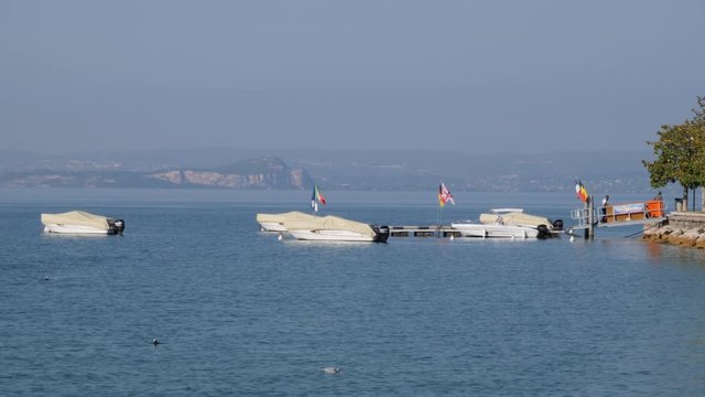 Boats and Ferry on Garda Lake, Italy. Bardolino bay area
