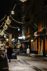 Stockholm, Sweden A lone pedestrian on Drottninggatan in the early morning at Christmas