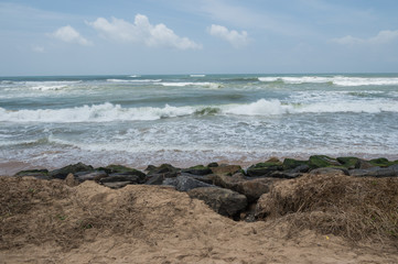 Fototapeta na wymiar The sand beach and rocky shore of the Indian ocean, Ahungalla, Sri Lanka
