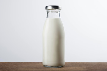 Bottle of fresh milk on a wooden, gray white background. Healthy food.