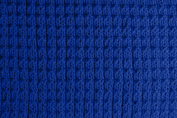 2020 - classic blue. Knitted blue woolen texture. Fabric background top view.