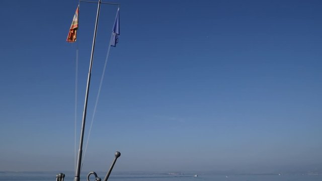 Boats and Flags on Garda Lake, Italy. Panoramic Bardolino bay area
