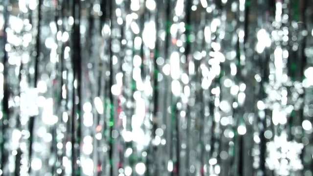 Abstract shiny background with silver defocused bokeh. Beautiful dynamic background in shining lights and sparkling particles. Festive mood. Christmas or holiday theme