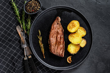 Beef marble flank steak medium rare. Black background. Top view