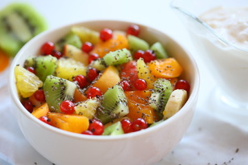 Healthy summer Breakfast concept, fruit salad in  a white bowl. Vegetarian food concept. Weight loss concept.