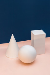 Geometric plaster figures of the statue on a classic blue and pink-beige background