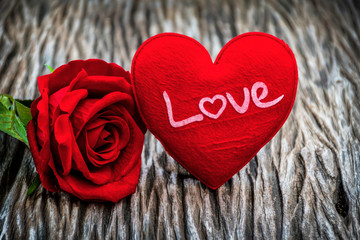 Fototapeta premium red heart shape and red rose on wooden background, vintage style, love and valentine concept.