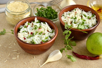 Basmati rice with lime, cilantro and garlic in ceramic bowls