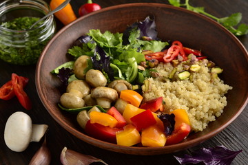 Salad with quinoa, sweet pepper, mushrooms, herbs and pistachios. Healthy nutrition. Vegetarian concept.