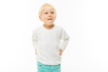 charming blond boy in a white t-shirt thinking on a white background