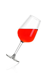 Full glass of rose wine isolated on white background. The glass is tilted to the right.