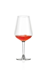 A glass of rose wine half filled, isolated on a white background. The wine boils in the glass.