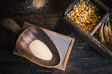 wooden cuisine wheat and corn seeds to made homemade cornmeal.  cereal grains on rustic wooden table