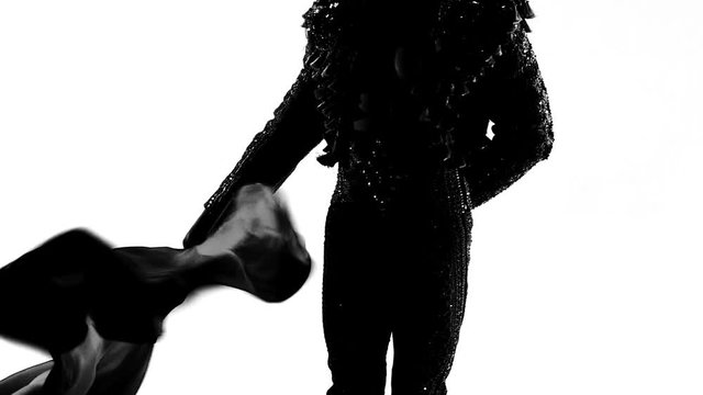 Silhouette Dancing man wearing a toreador costume. Isolated on white background in full length. Close up, slow motion.