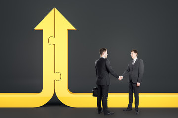 Businessmen shaking hands and yellow arrow