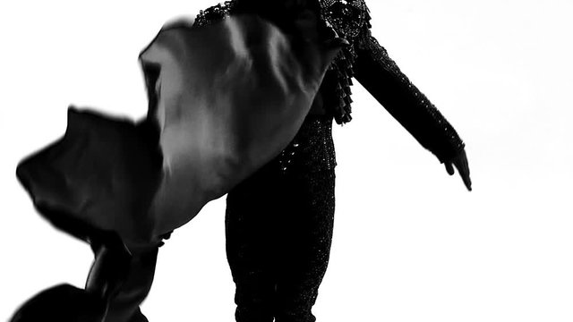 Silhouette Dancing man wearing a toreador costume. Isolated on white background in full length. Close up, slow motion.